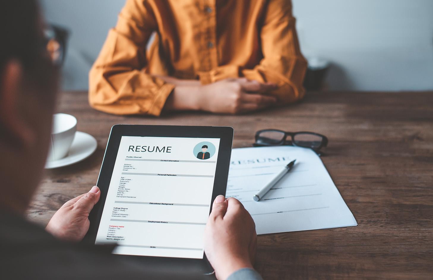 HR managers are interviewing job applicants who fill out their resume